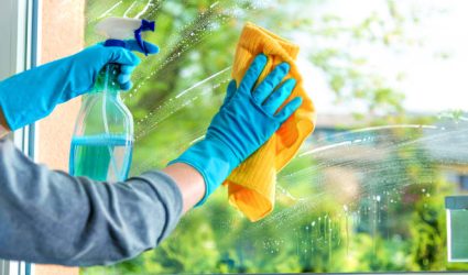 Cleaning window pane with detergent, spring cleaning concept
